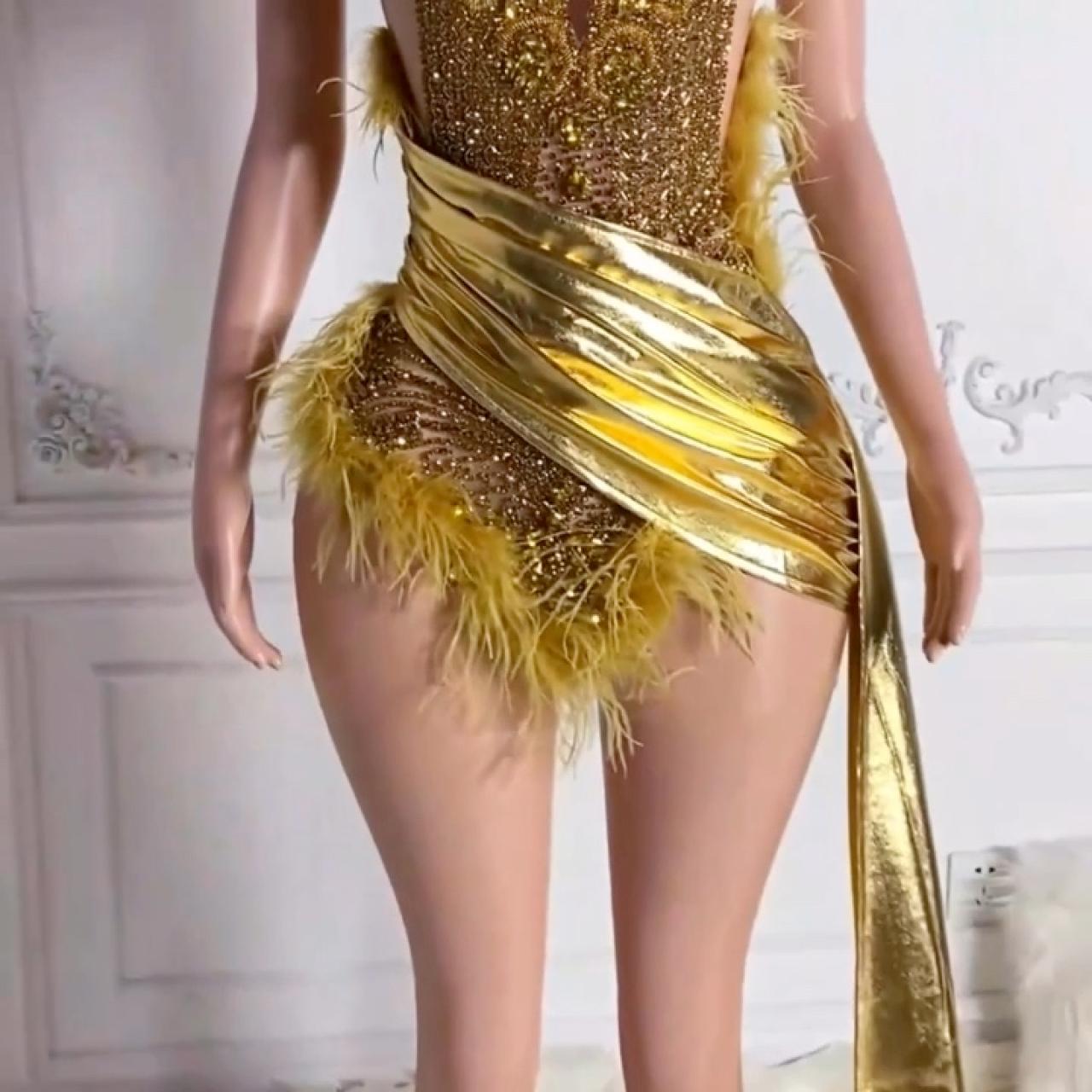 Gold feather mini dress. The dress features a beaded... | Depop